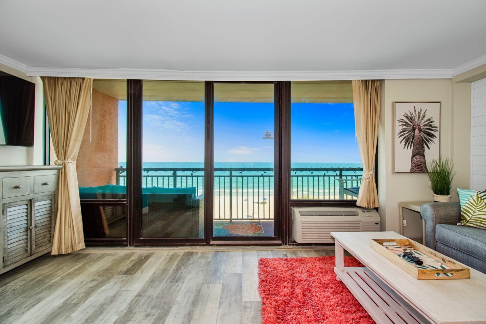 A condo near a beach with a balcony overlooking the sea