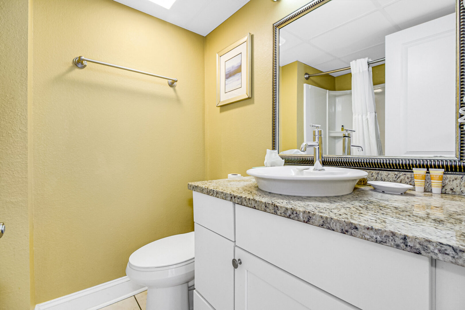 A bathroom with yellow walls